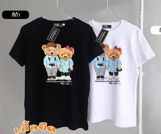Black and white t-shirts with teddy bear graphic on hangers against a gray background