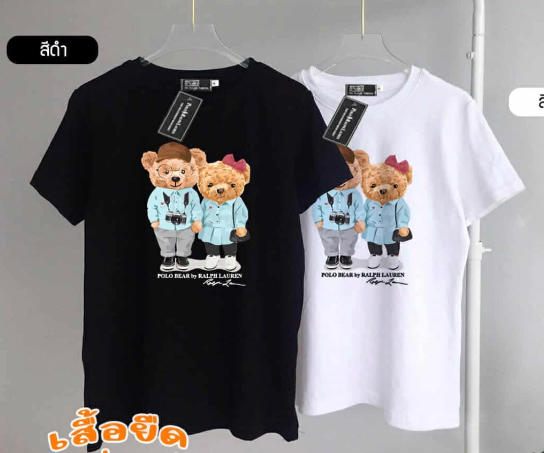 Black and white t-shirts with teddy bear graphic on hangers against a gray background